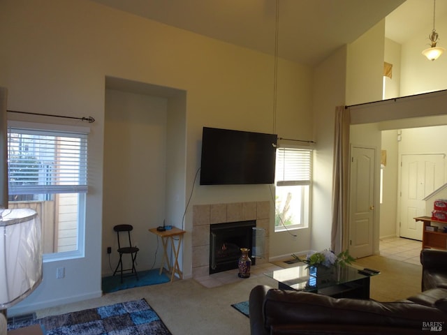 living room with a fireplace, high vaulted ceiling, and light carpet