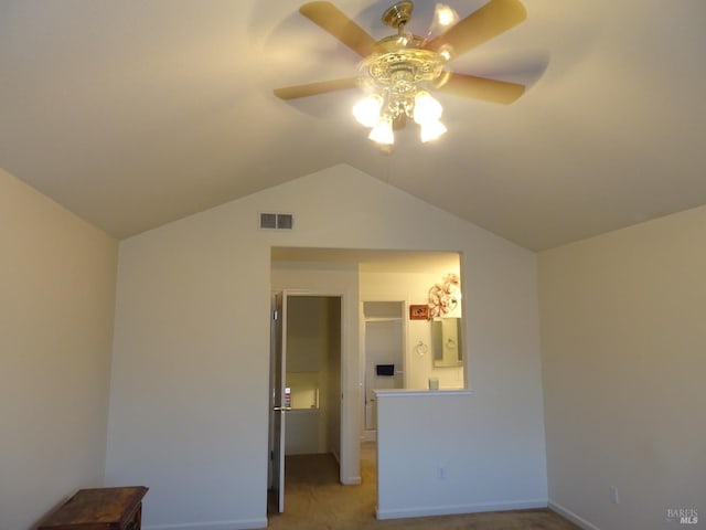 unfurnished bedroom featuring ceiling fan, light colored carpet, and lofted ceiling