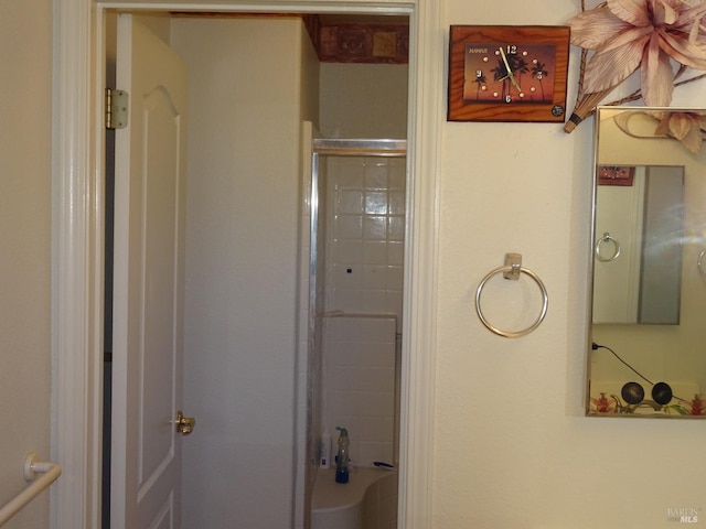 bathroom with a shower with door