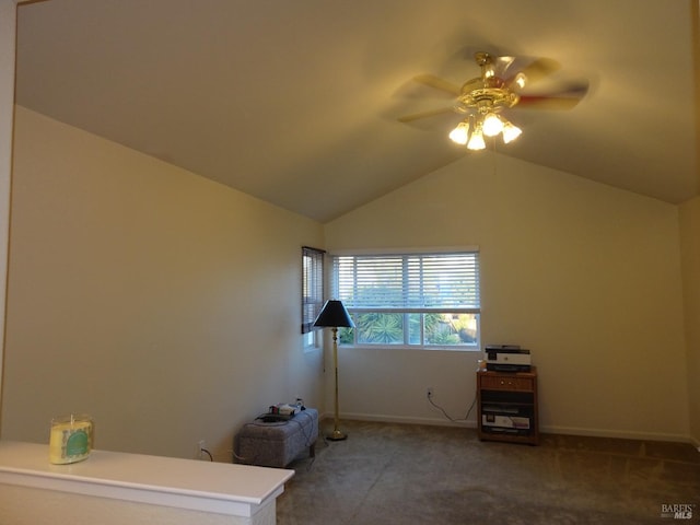 interior space featuring dark carpet, vaulted ceiling, and ceiling fan