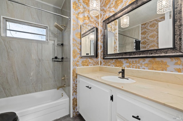 bathroom with tiled shower / bath and vanity