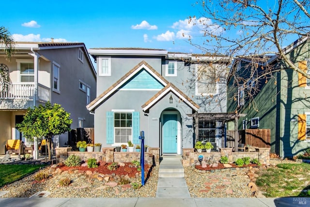 view of front of house with a balcony and a pergola