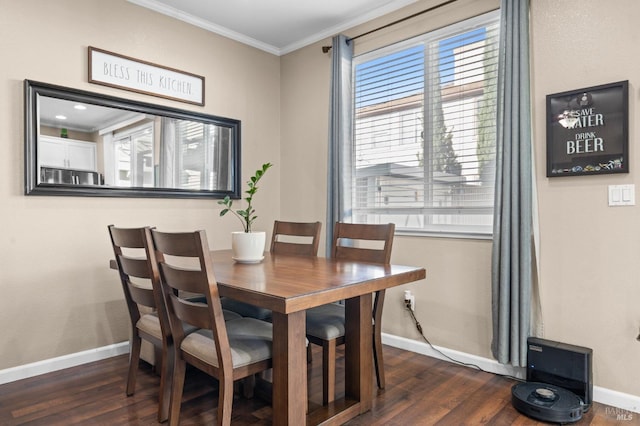 dining space featuring baseboards, ornamental molding, and dark wood-type flooring