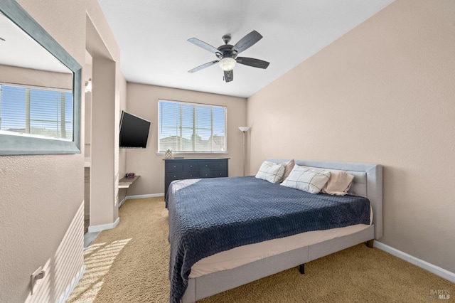 bedroom featuring light carpet, a ceiling fan, and baseboards