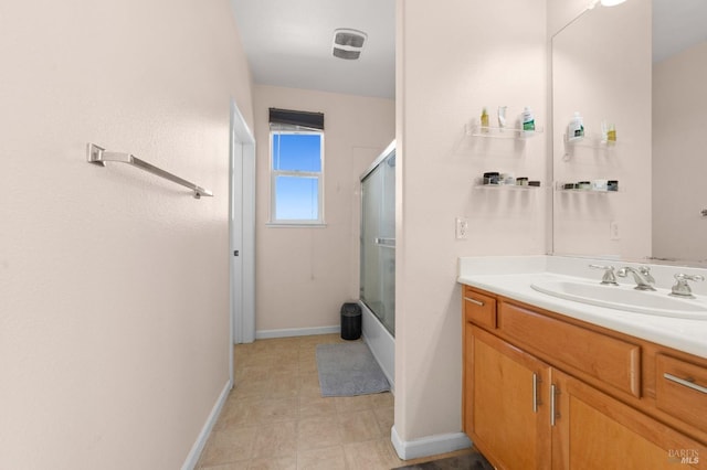 full bathroom featuring shower / bath combination with glass door, visible vents, baseboards, and vanity