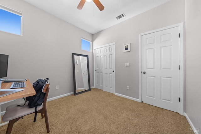 office featuring light carpet, visible vents, and baseboards