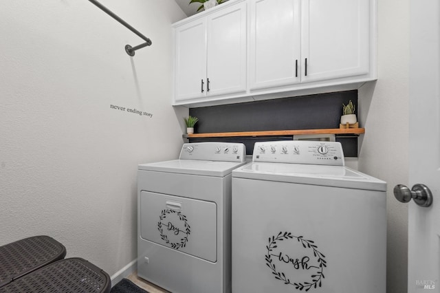 clothes washing area with cabinet space and washer and dryer