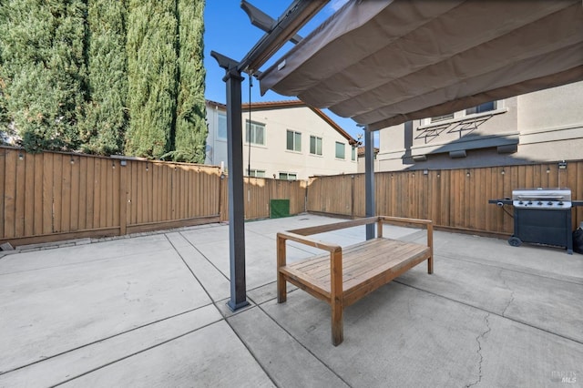 view of patio / terrace featuring grilling area, a fenced backyard, and a pergola