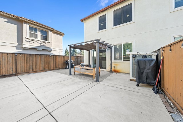 rear view of property featuring a patio area, stucco siding, a fenced backyard, and a pergola