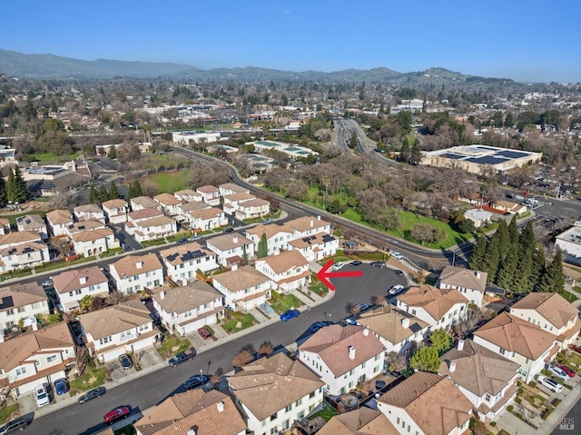 birds eye view of property with a mountain view and a residential view