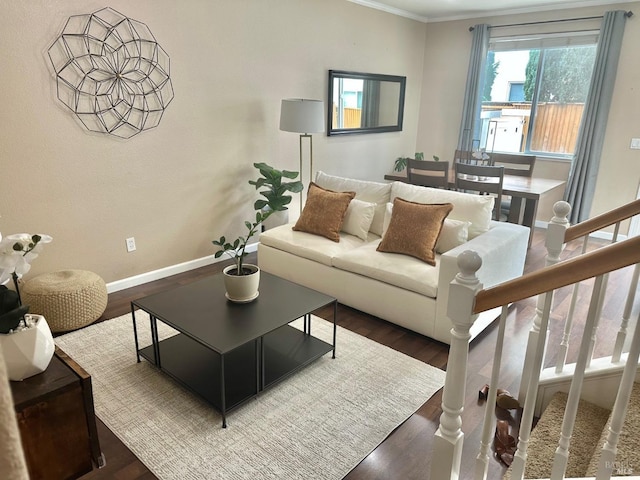 living area featuring dark wood-style floors, stairway, baseboards, and crown molding