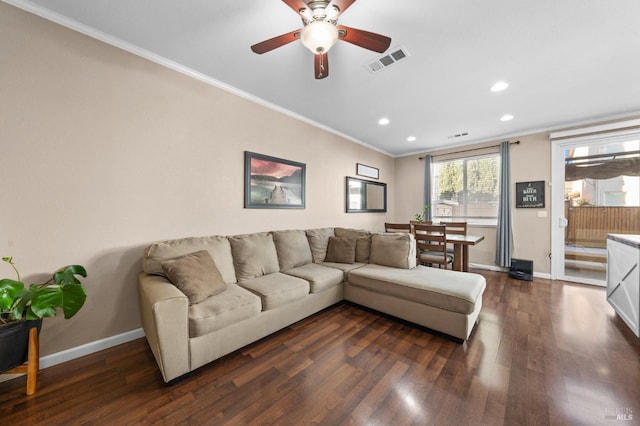 living area featuring visible vents, ornamental molding, dark wood finished floors, and baseboards