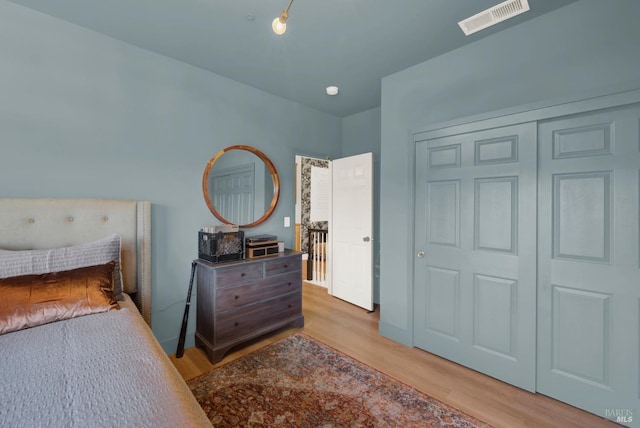 bedroom with a closet and hardwood / wood-style floors