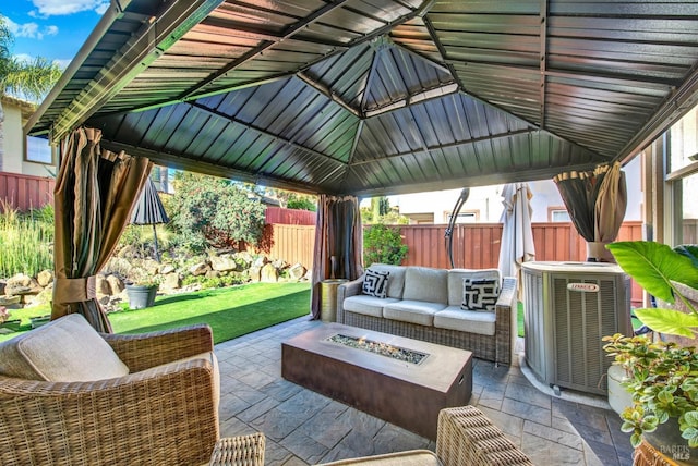 view of patio / terrace with an outdoor living space with a fire pit, a gazebo, and central AC