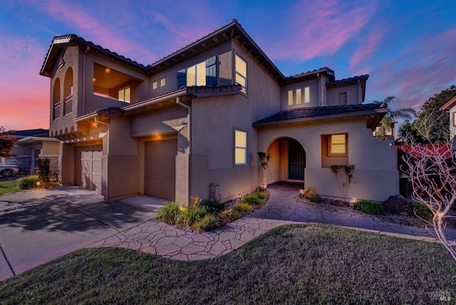 mediterranean / spanish-style house with a garage