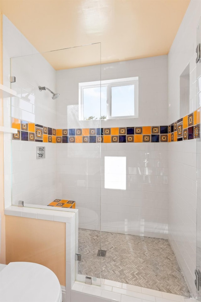 bathroom featuring walk in shower and toilet