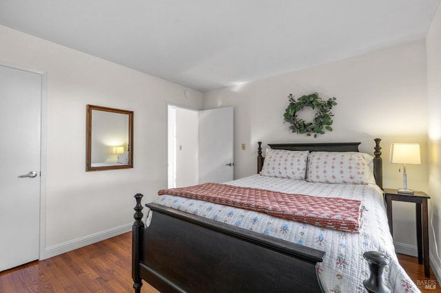 bedroom with dark hardwood / wood-style flooring