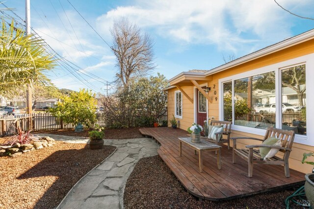 wooden terrace with an outdoor hangout area