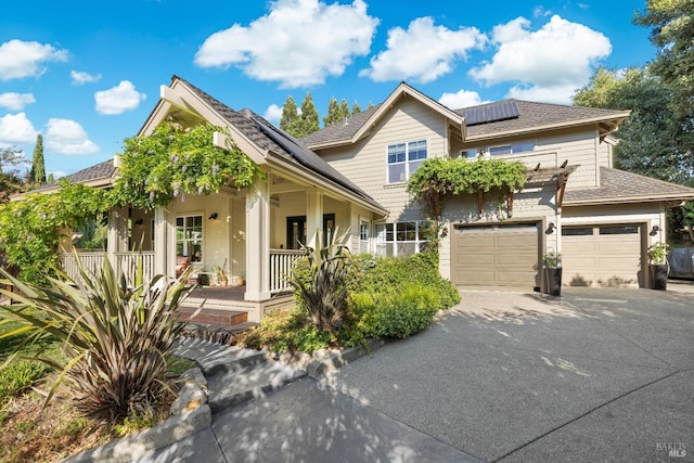 view of front of property featuring solar panels and a porch