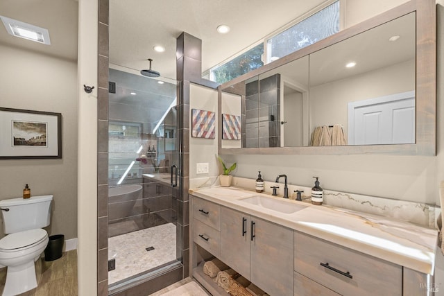 bathroom featuring toilet, walk in shower, and vanity