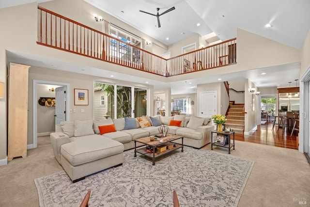 carpeted living room featuring a towering ceiling