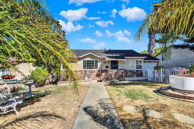 view of front of property with a garage and a front yard