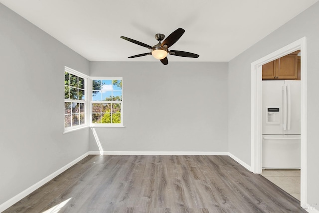 unfurnished room with ceiling fan and light hardwood / wood-style flooring