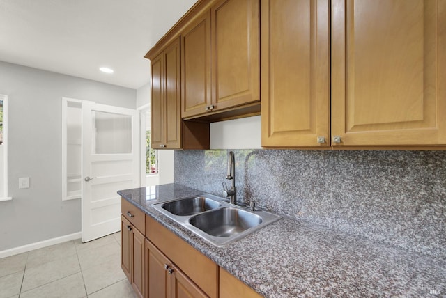 kitchen with sink, decorative backsplash, and light tile patterned flooring