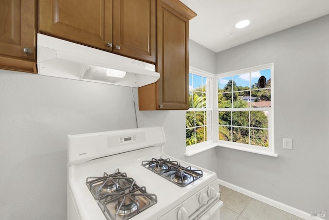 kitchen with white range with gas cooktop and light tile patterned floors