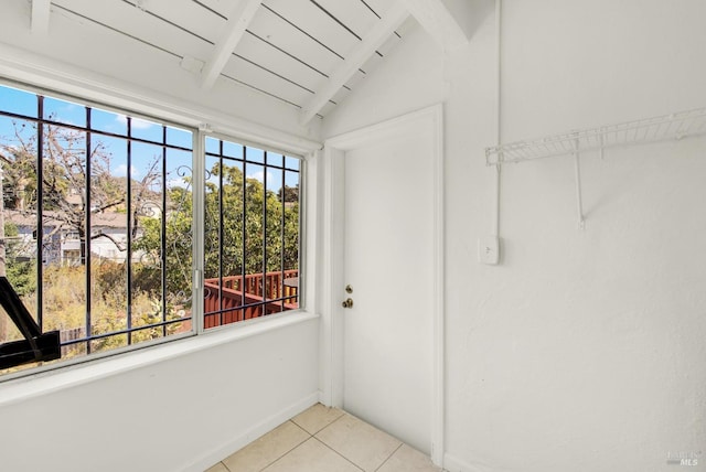 unfurnished sunroom with lofted ceiling with beams