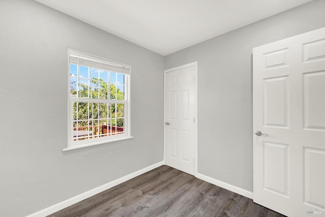 unfurnished bedroom featuring dark hardwood / wood-style flooring