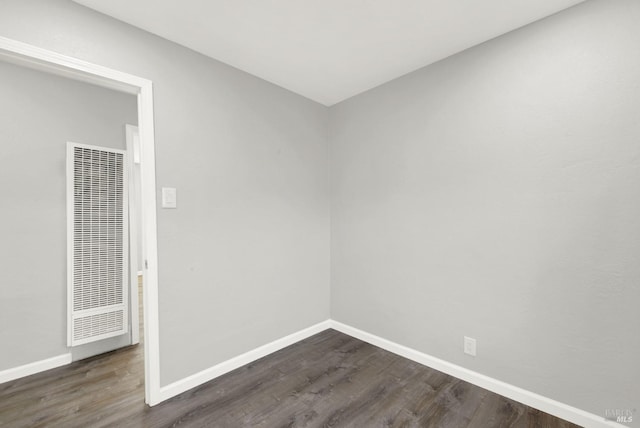 spare room with dark hardwood / wood-style flooring