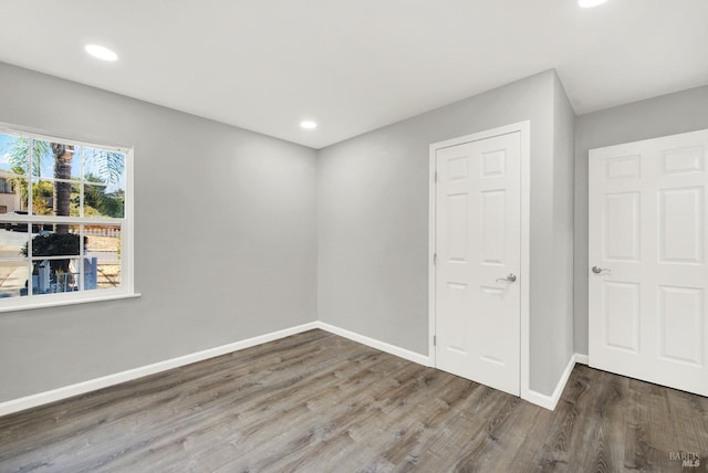 empty room with hardwood / wood-style flooring