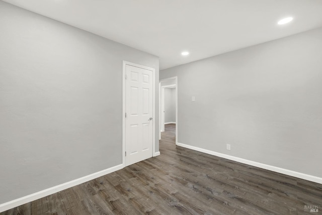 unfurnished room featuring dark wood-type flooring