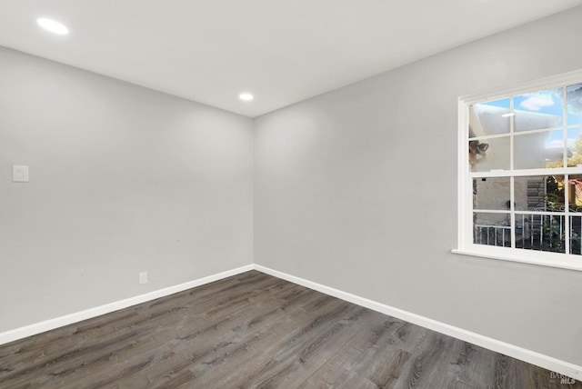 spare room with dark hardwood / wood-style floors