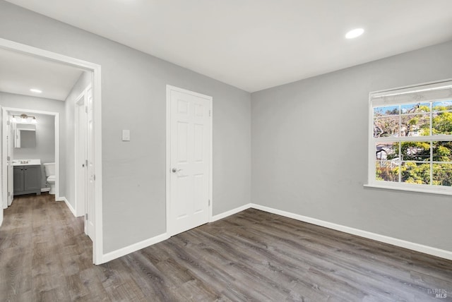 spare room with dark hardwood / wood-style floors