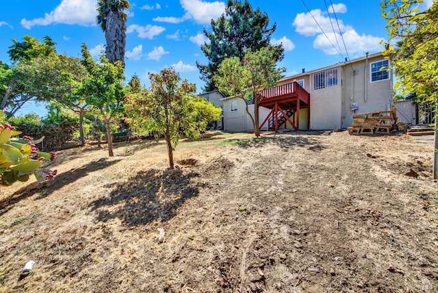 view of yard with a wooden deck