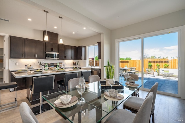 dining space with light hardwood / wood-style flooring