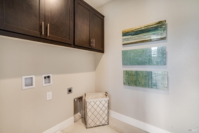 washroom featuring washer hookup, cabinets, light tile patterned floors, and electric dryer hookup