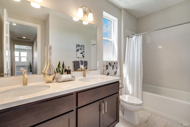 full bathroom featuring a wealth of natural light, toilet, vanity, and shower / tub combo with curtain