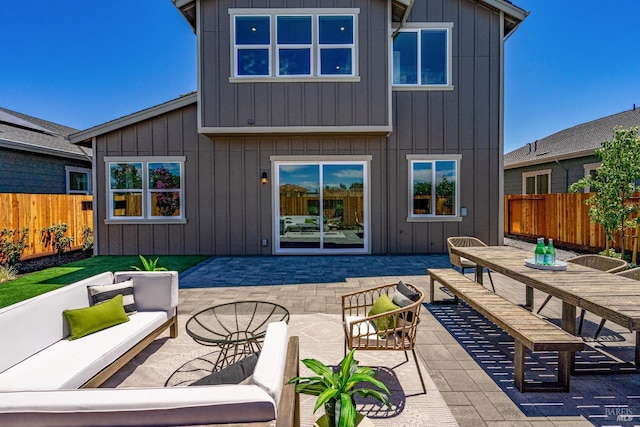 rear view of property with an outdoor hangout area and a patio area