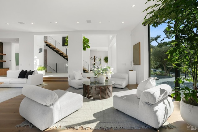 living area featuring recessed lighting, stairs, and wood finished floors