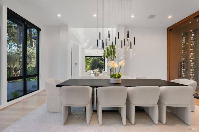 dining room with recessed lighting and light wood-style floors