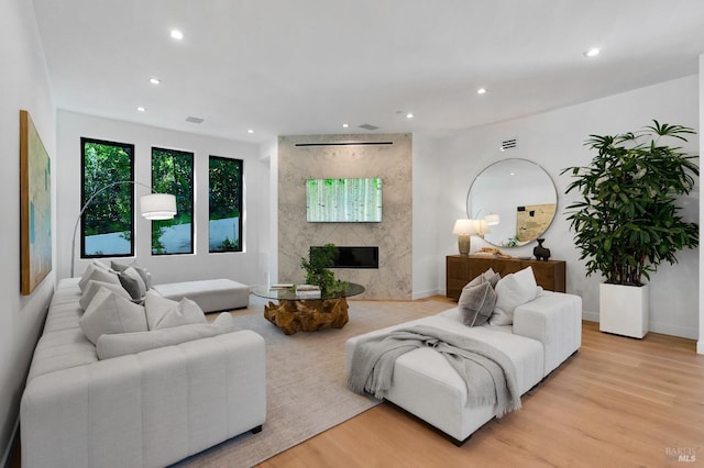 living room featuring a fireplace and light hardwood / wood-style flooring