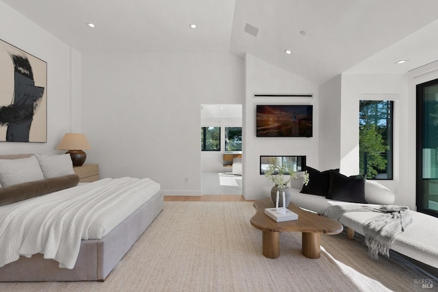 bedroom with lofted ceiling and light wood-type flooring