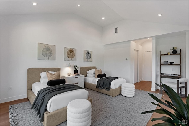 bedroom featuring lofted ceiling and hardwood / wood-style flooring