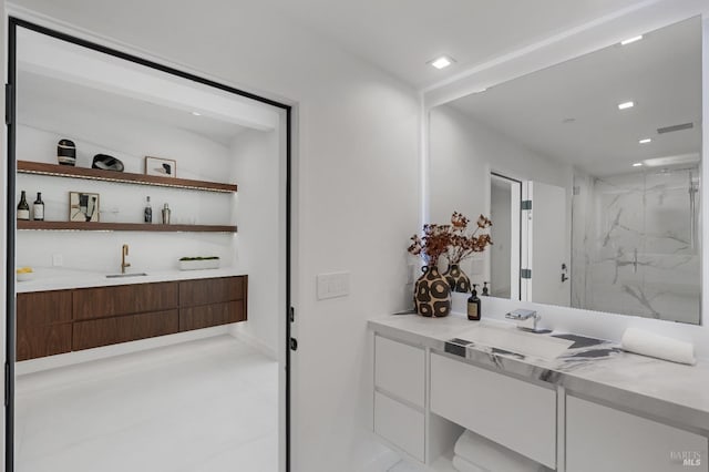 full bathroom with recessed lighting, a marble finish shower, and vanity