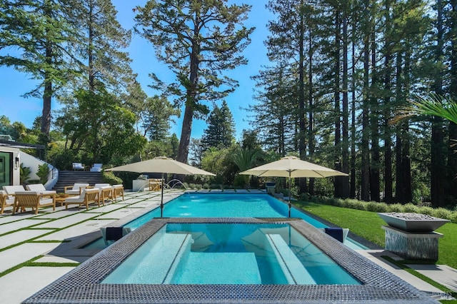 view of swimming pool featuring a patio area