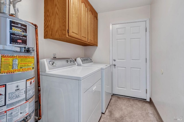 clothes washing area with cabinets, separate washer and dryer, and gas water heater