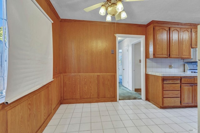 kitchen featuring ceiling fan and tasteful backsplash